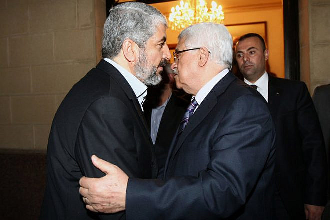 Hamas leader Khaleed Meshaal (left) meets with Palestinian Authority leader Mahmoud Abbas in Cairo, to implement the terms of a reconciliation deal they signed in the Egyptian capital in May 2011, which called for an interim government and general elections in a year, on Feb. 23, 2012. Photo by Mohammed al-Hums/Flash90.