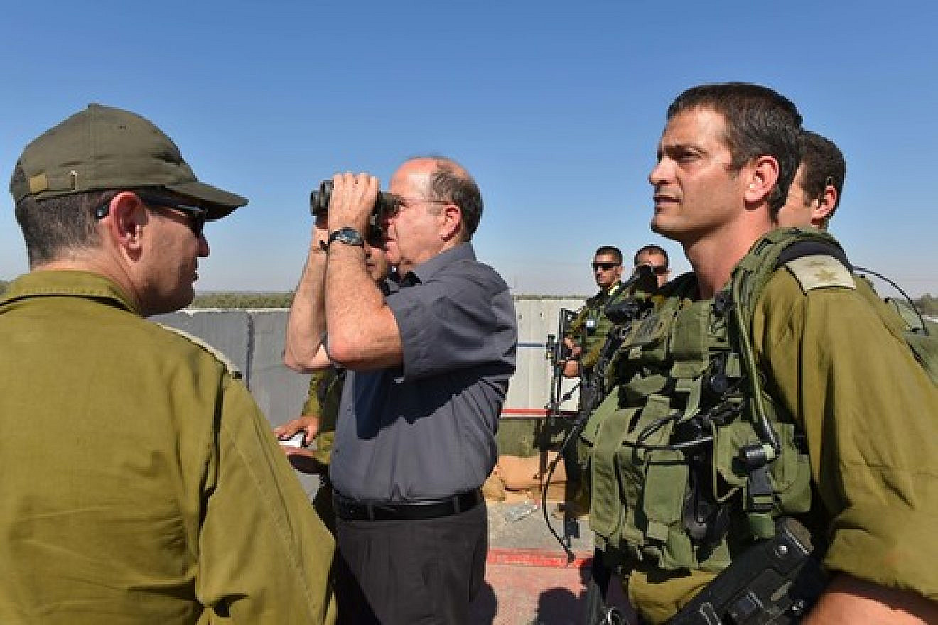 Click photo to download. Caption: Israeli Defense Minister Moshe Ya'alon (with binoculars) pictured during a visit to the Israel Defense Forces (IDF) Southern Command's Gaza Division on Tuesday. The IDF launched Operation Protective Edge in Gaza in response to escalated rocket fire by Hamas. Credit: Ariel Hermoni/Ministry of Defense/Flash90.