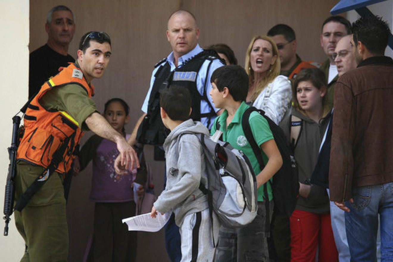 Click photo to download. Caption: Students are evacuated from a school in the southern Israeli city of Sderot in November 2009 after a Qassam rocket hit the building. Photo by Nati Shohat/Flash90.