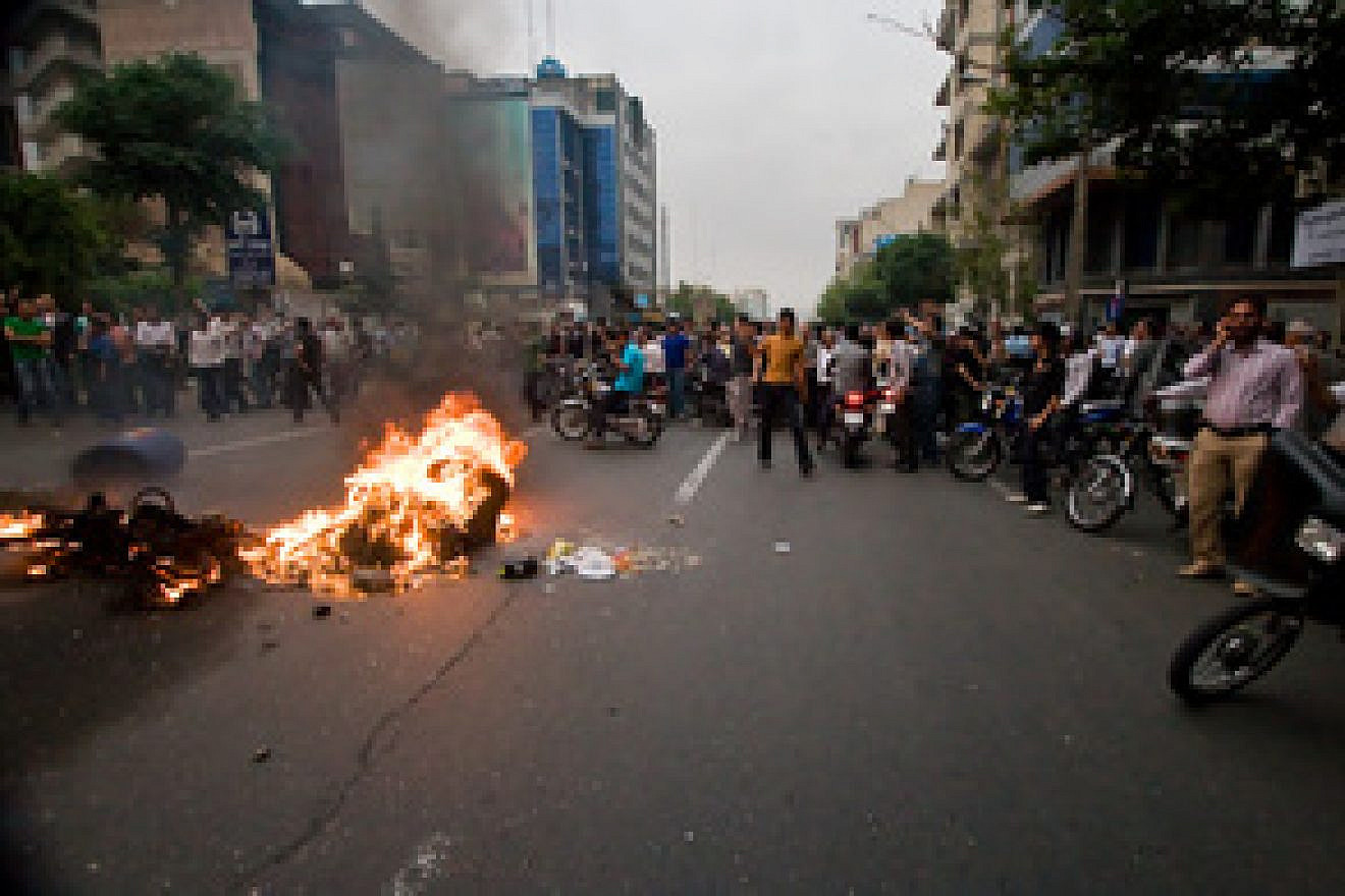 Iranians in Tehran protest the country's elections in June 2009, in which reformist Mir-Hossein Mousavi was defeated. Four years later, the newest presidential candidate seeking reform in Iran is Dr. Hooshang Amirahmadi. Credit: Wikimedia Commons.
