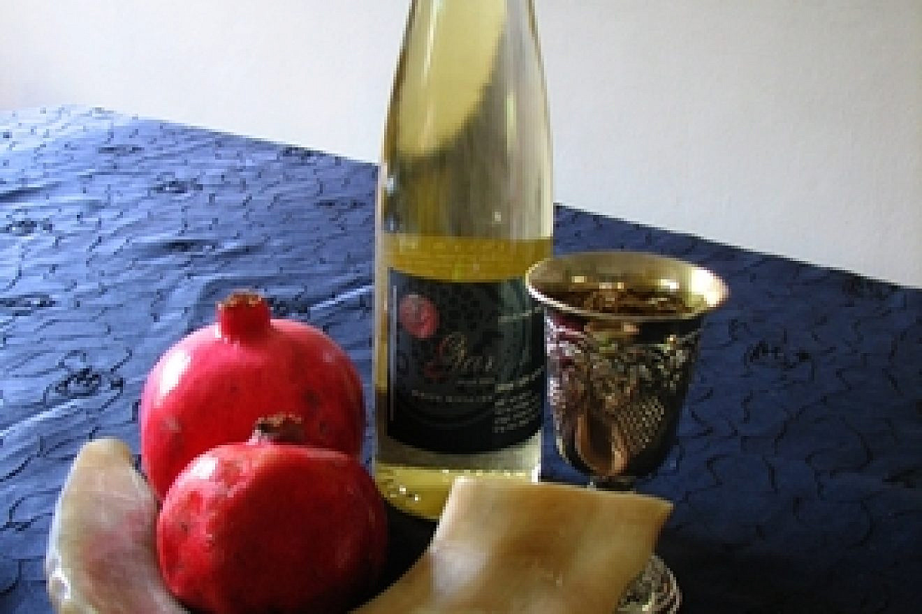 Click photo to download. Caption: A table of traditional Rosh Hashanah items. Credit: Gilabrand.