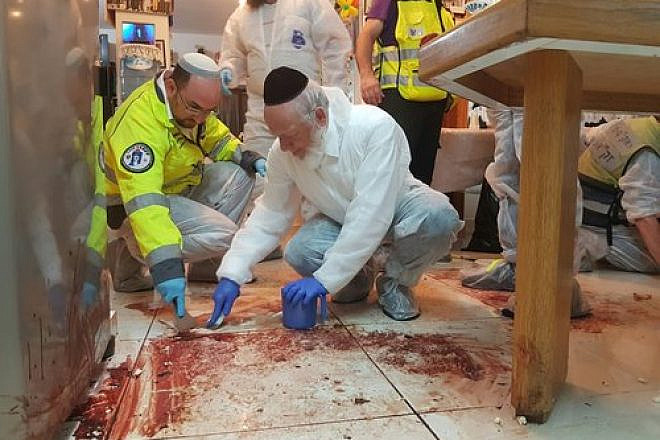 Yehuda Meshi Zahav (center) and ZAKA volunteers collect human remains from the scene of the Palestinian terror attack at the Salomon family home in Halamish on July 21, 2017. Credit: Yehezkiel Itkin/ZAKA.