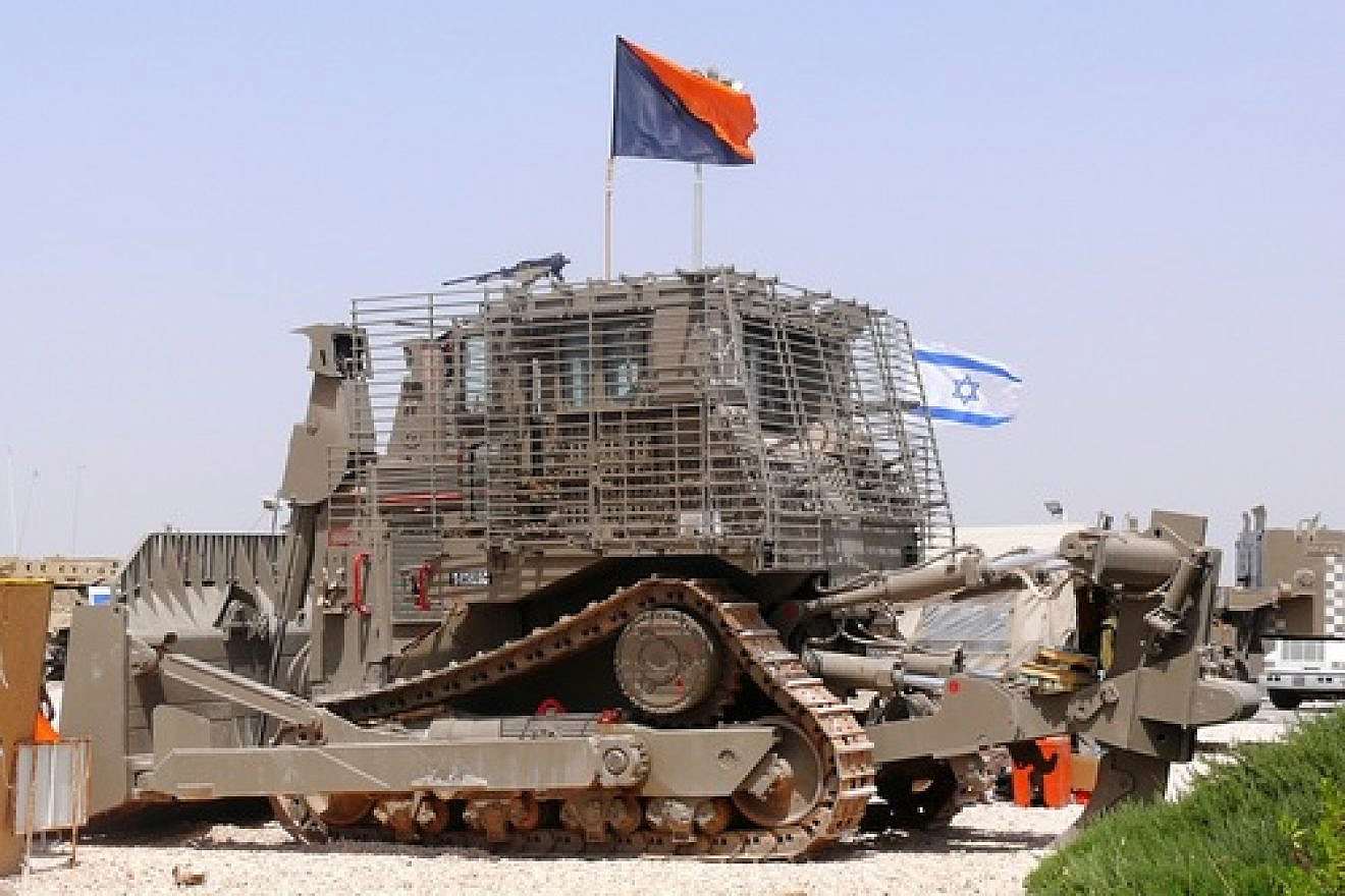 An IDF Caterpillar D9 bulldozer. In calling for a boycott of Caterpillar—long a target of the anti-Israel BDS movement—Dalit Baum speaks of the bulldozers' use to “raze Palestinian homes [and] construct the separation barrier,” ignoring the fact that the demolished buildings were being used to shield attacks or belonged to terrorists who murdered innocent civilians, writes Robin Joshowitz. Credit: MathKnight via Wikimedia Commons.