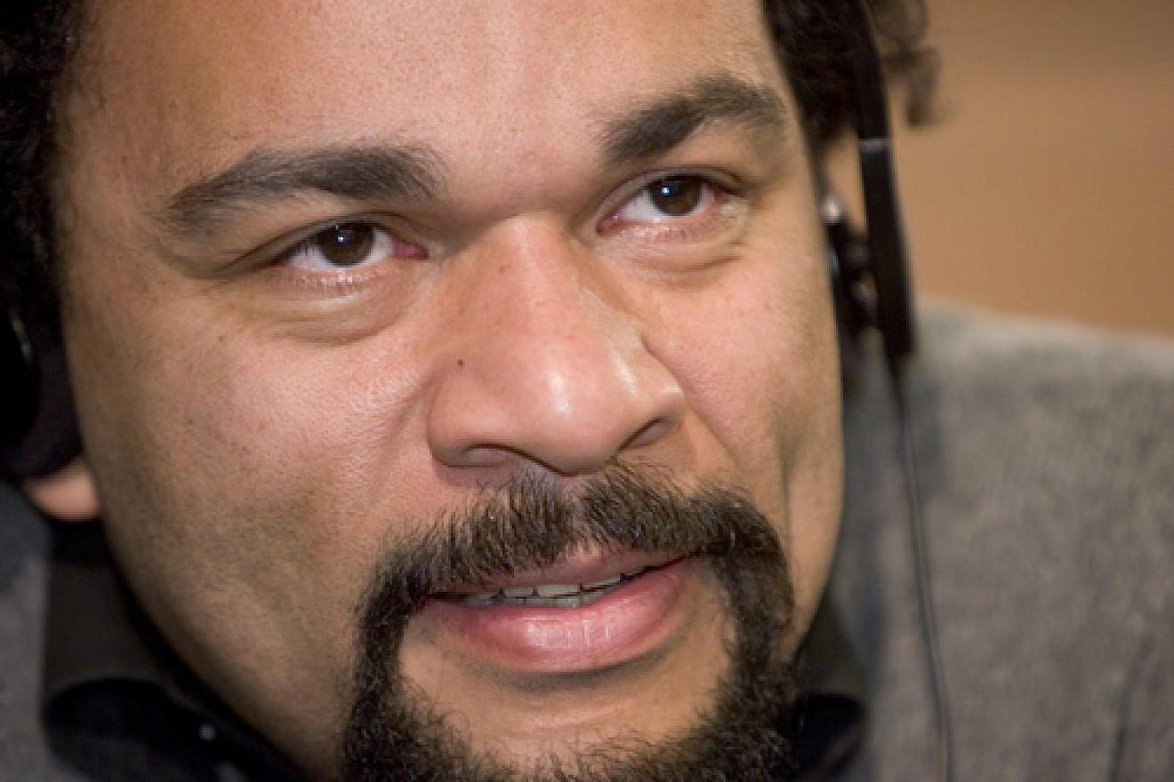 Click photo to download. Caption: Dieudonné M’bala M’bala—the anti-Semitic French comedian who invented the quenelle. Credit: Axis for Peace via Wikimedia Commons.