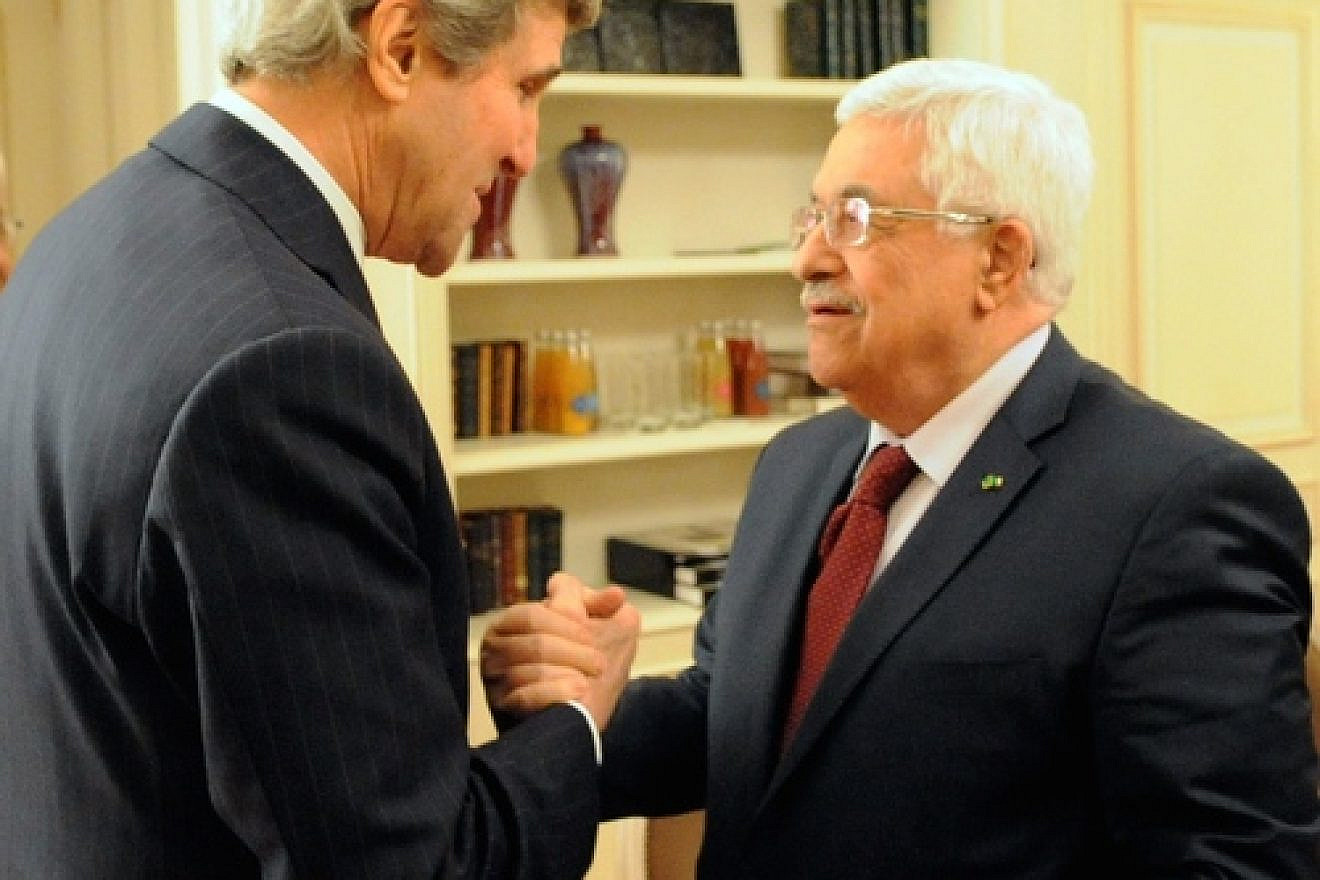 U.S. Secretary of State John Kerry and Palestinian Authority leader Mahmoud Abbas shake hands before a meeting in Paris on Feb. 19, 2014. Credit: U.S. State Department.
