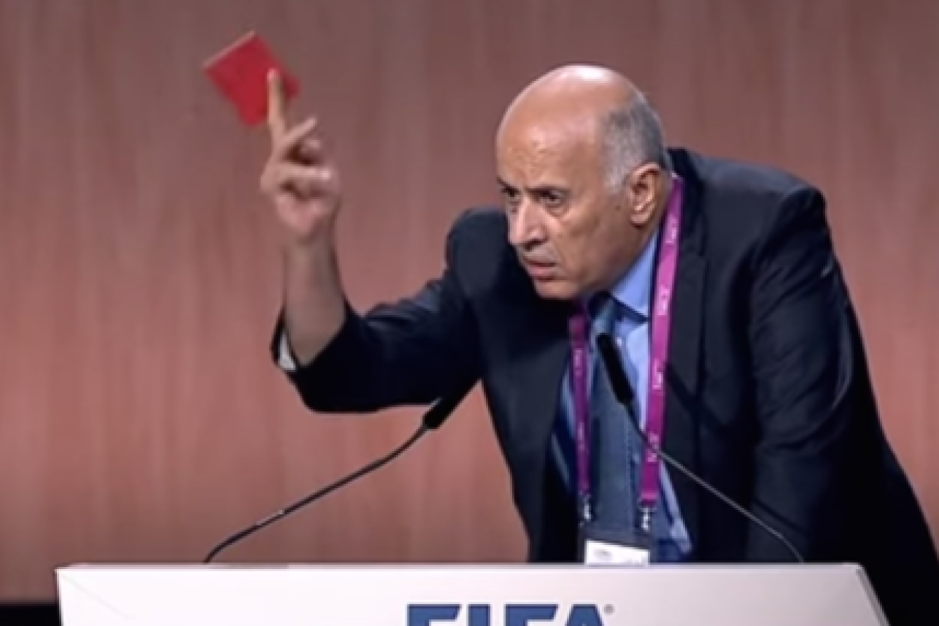 Palestinian soccer official Jibril Rajoub waives a symbolic red penalty card at Israel during the 65th FIFA Congress in 2015. Credit: YouTube.
