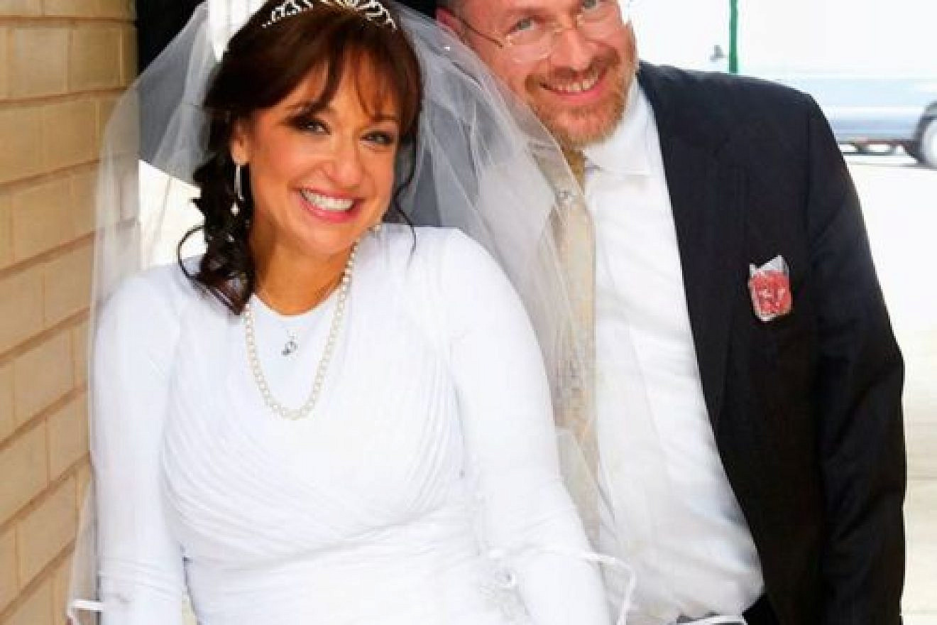 Chayim Lando and his third wife, Lea Sternbach. Lando, who has 19 children and stepchildren between the ages of 5 and 28 from his three marriages, says of parenting and step-parenting: “You have to figure out the appropriate thing for each child.” Credit: Courtesy of the Lando family.