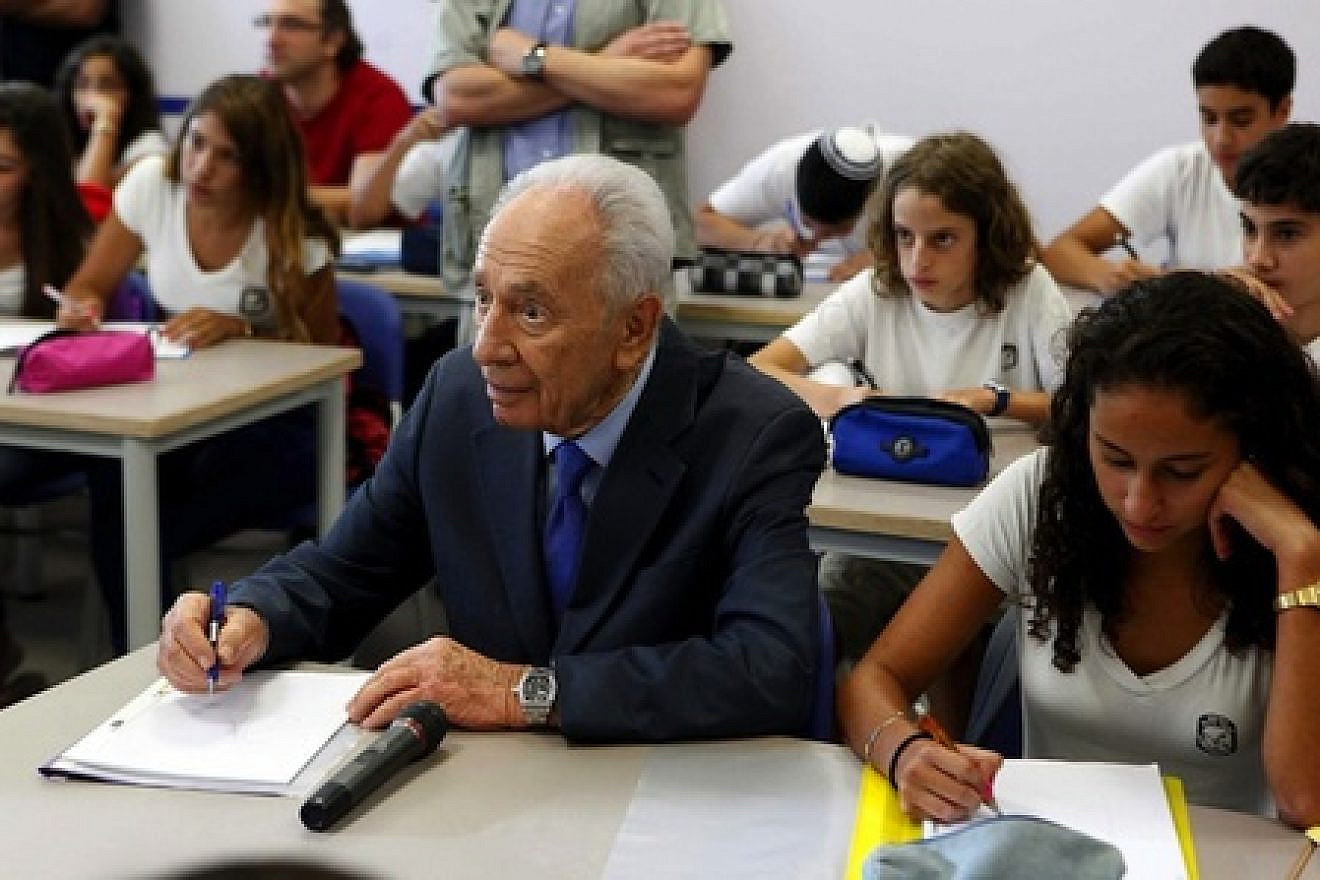 Israeli President Shimon Peres sits with first-graders on the first day of school in the Sha'ar Hanegev area in southern Israel, the same day a Qassam rocket was fired into the area from the Gaza Strip. Photo by Edi Israel/Flash90.