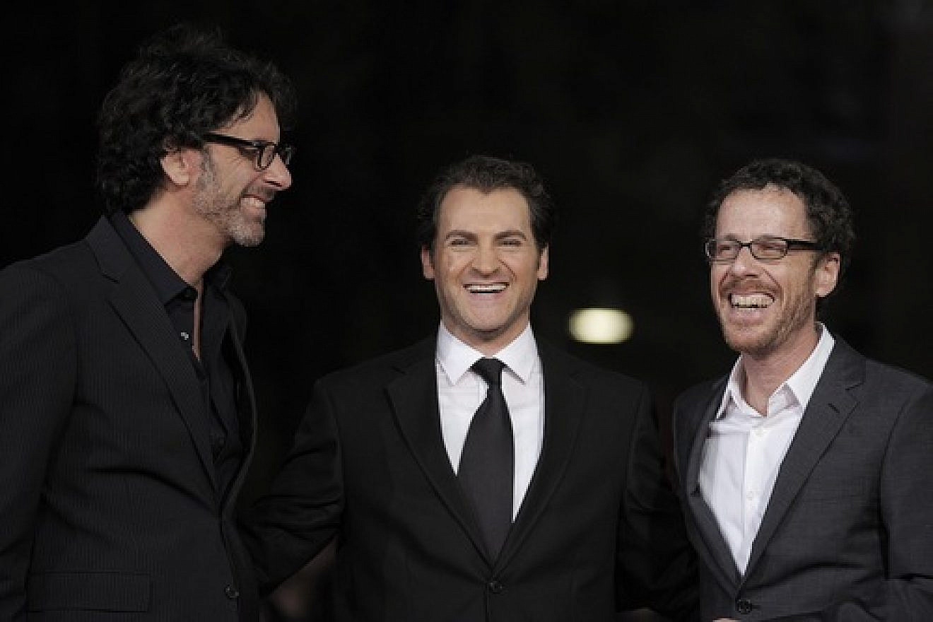 U.S. directors and producers Joel (left) and Ethan Coen pose for photographs with US actor and cast member Michael Stuhlbarg on the red carpet as they arrive at the screening of their film, "A Serious Man" during the 4th annual Rome Film Festival in Italy on Oct. 22, 2009. Credit: EPA/Guida Montani.
