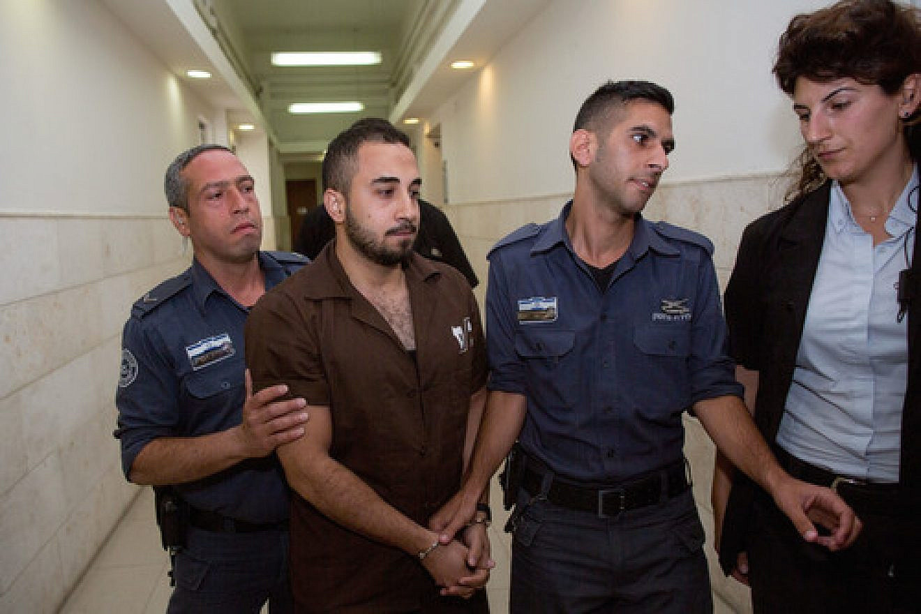 Click photo to download. Caption: Khalil Adel Khalil (second from left), 25, of the A-Tur neighborhood in Jerusalem, is brought to Jerusalem's District Court on July 9, 2015. Khalil, who admitted to trying to join the Islamic State terror group in Syria, was sentenced to two years in prison. Credit: Yonatan Sindel/Flash90.