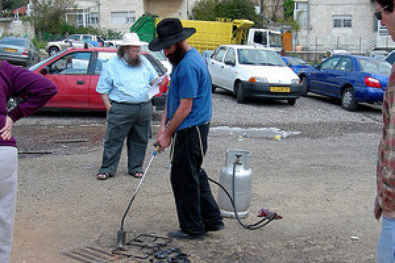 Koshering underway on a Jerusalem street. Credit: Judy Lash Balint.