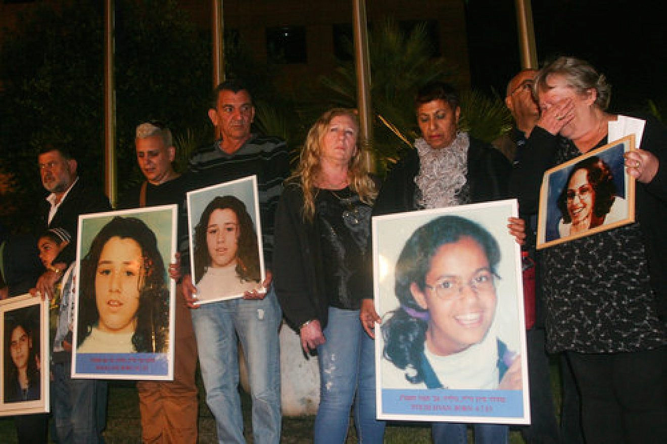 Relatives of the seven Israeli schoolgirls killed by Jordanian terrorist Ahmed Daqamseh in 1997 hold photos of the victims during a demonstration in front of the Jordanian Embassy in Ramat Gan, Israel. Credit: Flash90.