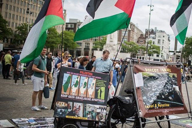 A pro-BDS display, with photos and PLO flags, at Dam Square in central Amsterdam, June 24, 2016. Photo by Hadas Parush/Flash90.