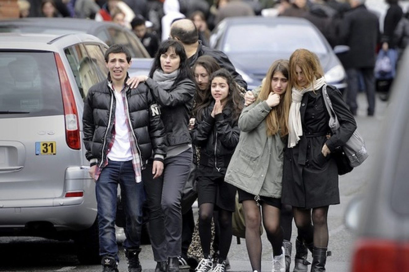 Distressed teenagers walk away from the Ozar Hatorah Jewish school in Toulouse, France, on March 19, 2012, where a man opened fire and killed a 30-year-old teacher and three young children, age 3, 6 and 10. Credit: EPA/MAXPPP/XAVIER DE FENOYL.