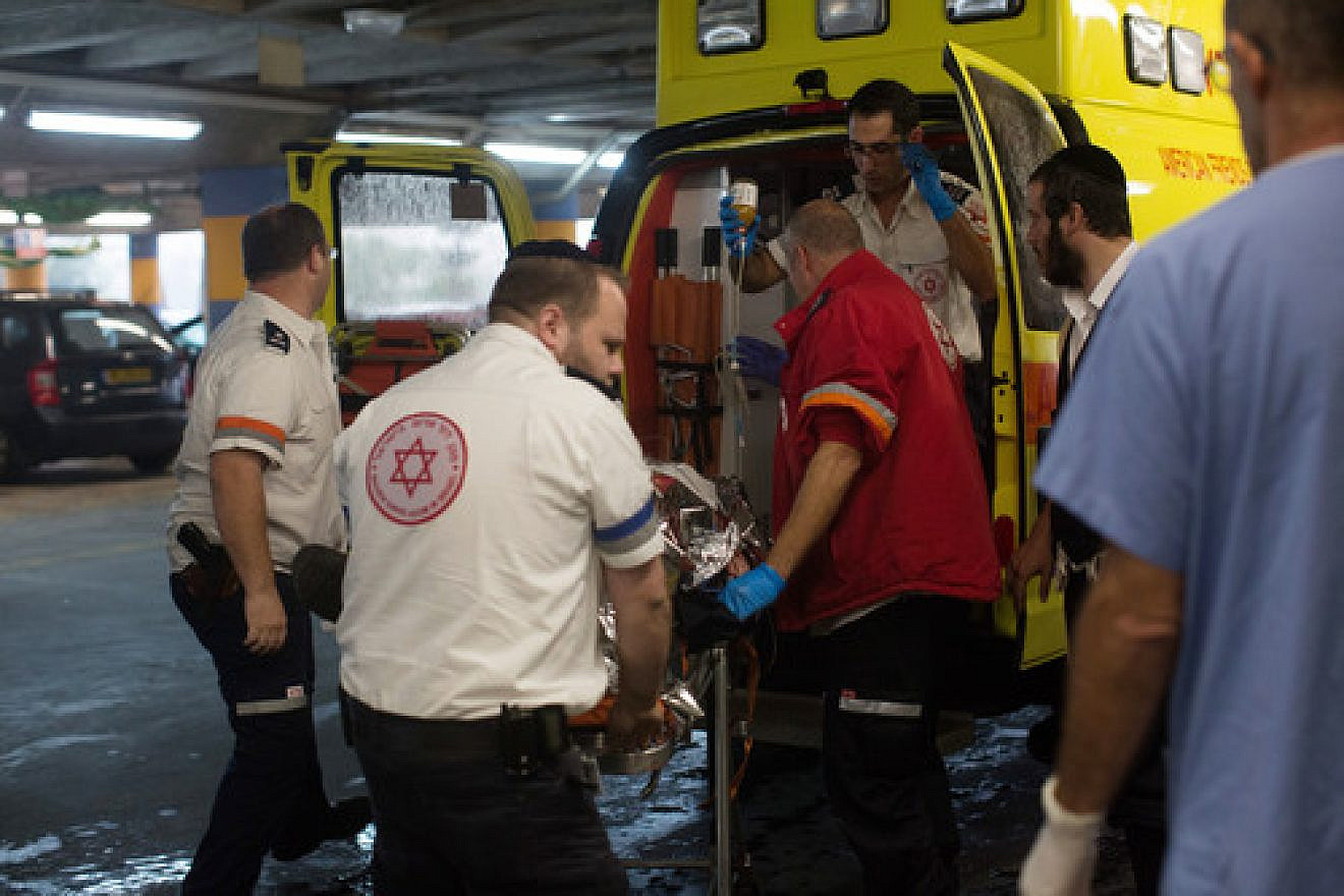 Click photo to download. Caption: Paramedics wheel a wounded Israeli man into the emergency room of the Shaare Zedek Medical Center on Nov. 6, 2015, after he was stabbed by a Palestinian attacker in the Sha'ar Binyamin industrial park in Judea and Samaria. Credit: Yonatan Sindel/Flash90.