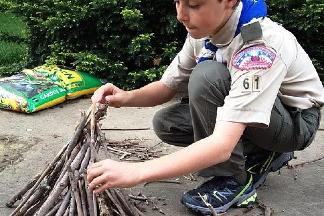 Click photo to download. Caption: Click photo to download. Caption: Boy Scout Abraham “Avi” Brudoley makes a bonfire. Credit: Maayan Jaffe.