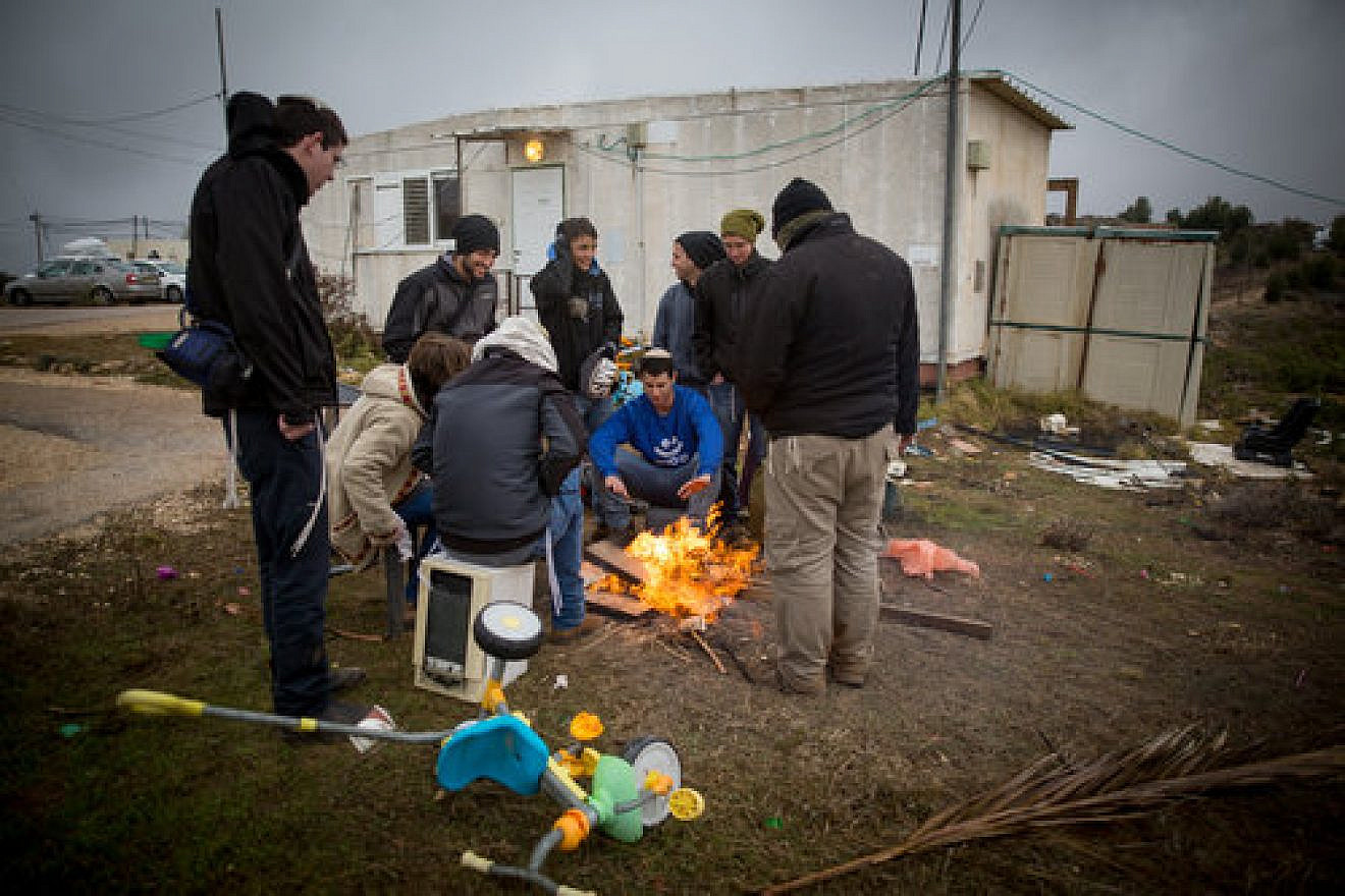 Amona residents cook coffee on Dec. 18, 2016. Residents of the 40-home West Bank settlement have agreed to a last-minute government proposal to shift the community to an adjacent plot of land on which the Israeli government will build 52 permanent homes and additional infrastructure. Miriam Alster/Flash90.