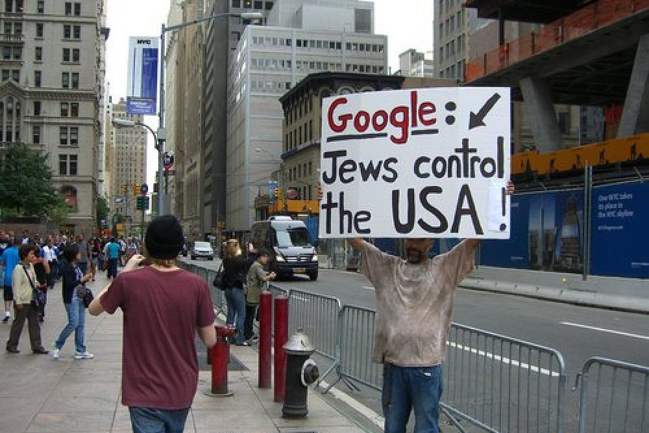 A man promotes an anti-Semitic conspiracy theory across the street from the former World Trade Center site on Sept. 11, 2011, the 10th anniversary of the 9/11 attacks. Credit: Luigi Novi via Wikimedia Commons.