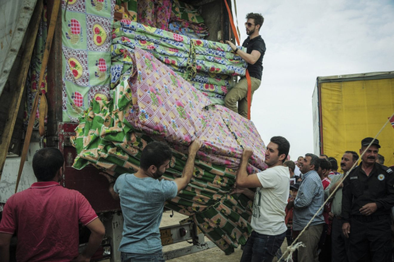 Click photo to download. Caption: In early October, IsraAID delivers mattresses and blankets (among other supplies) to Iraqi refugees in Kurdistan. Credit: IsraAID.