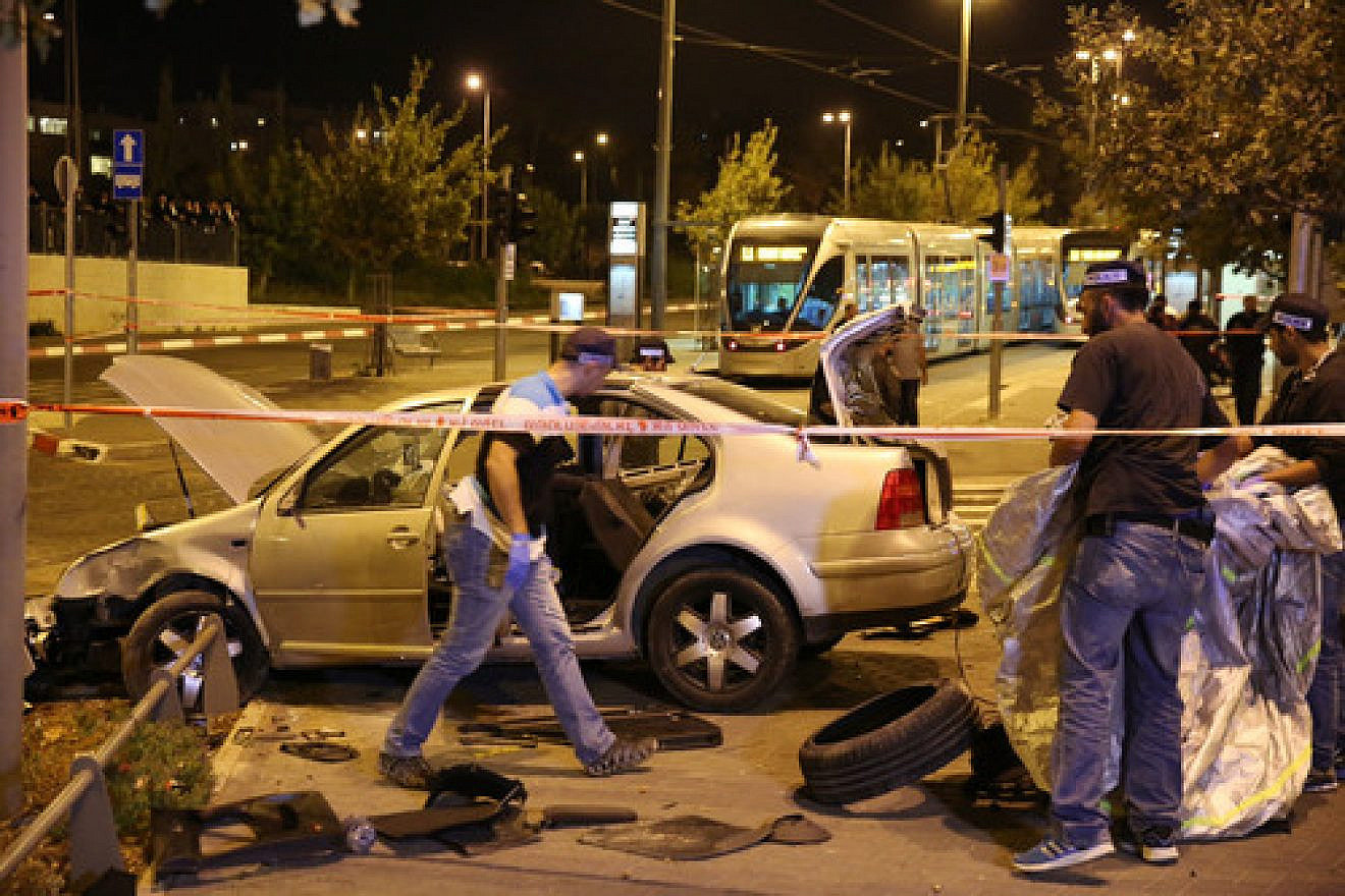 Click photo to download. Caption: Police and resuce personnel at the scene where a car crashed into Jerusalem's Ammunition Hill light rail station in a terror attack on October 22, 2014. Credit: Flash90.