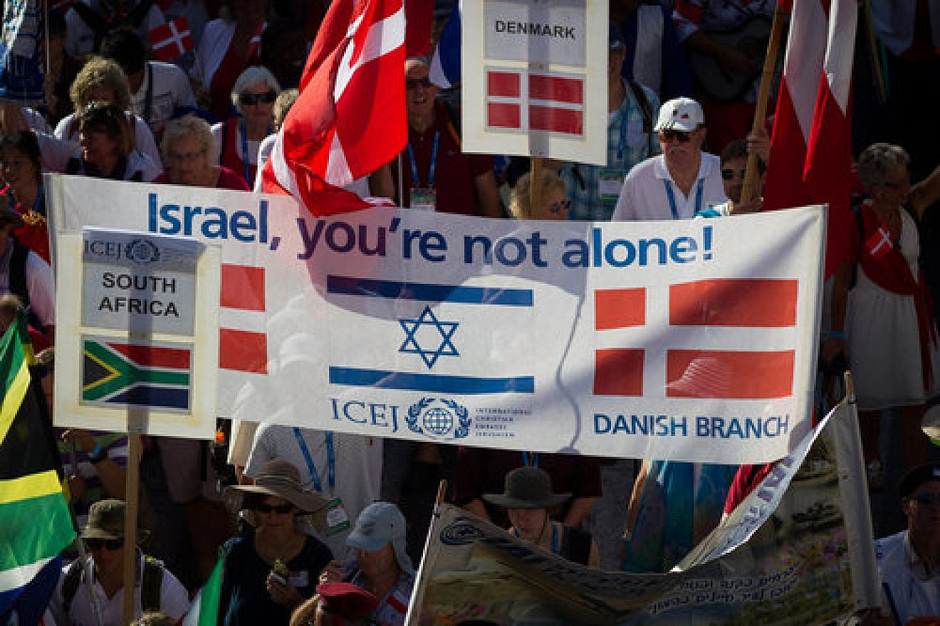 Evangelical Christians wave their national flags alongside the Israeli flag as they march in Jerusalem for International Christian Embassy Jerusalem’s Feast of Tabernacles celebration in October 2016. Credit: Sebi Berens/Flash90.