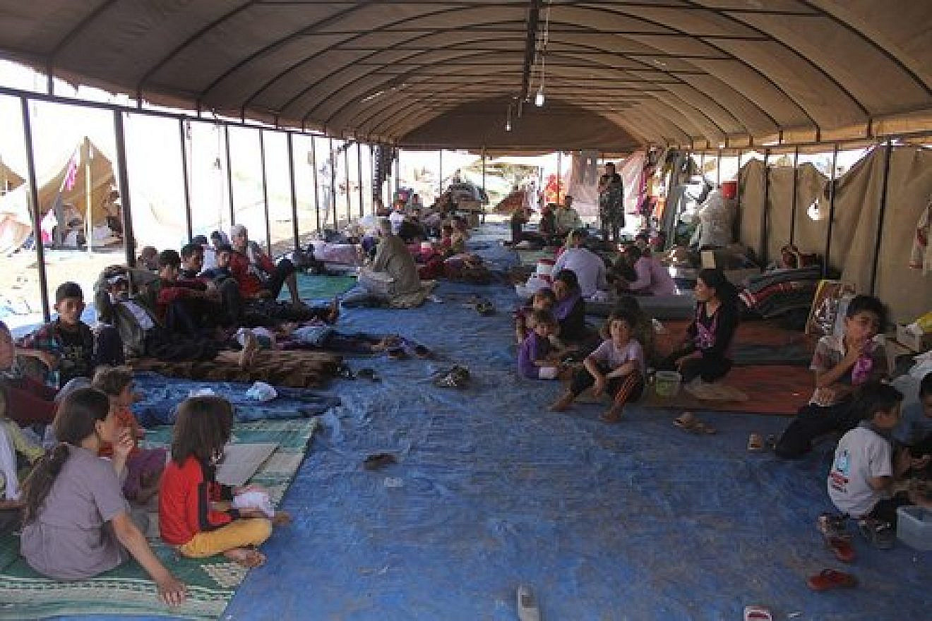 Iraqi Yazidi refugees in Newroz camp receive help from International Rescue Committee after fleeing their homes in 2014. Credit: Wikimedia Commons.