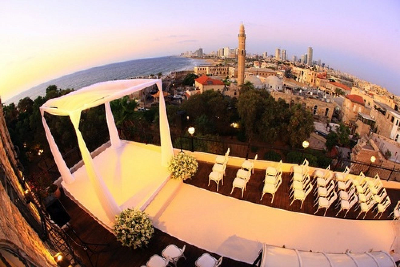 A rooftop chuppah (Jewish wedding canopy) with the city of Jaffa in the background. With interfaith marriages on the rise in America, Jewish seniors are adapting to new realities. Credit: Oren & Assi Eitan.