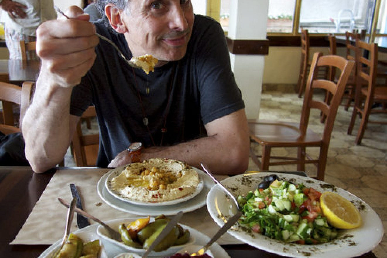 Film director Roger Sherman samples Israeli cuisine. Credit: “In Search of Israeli Cuisine.”
