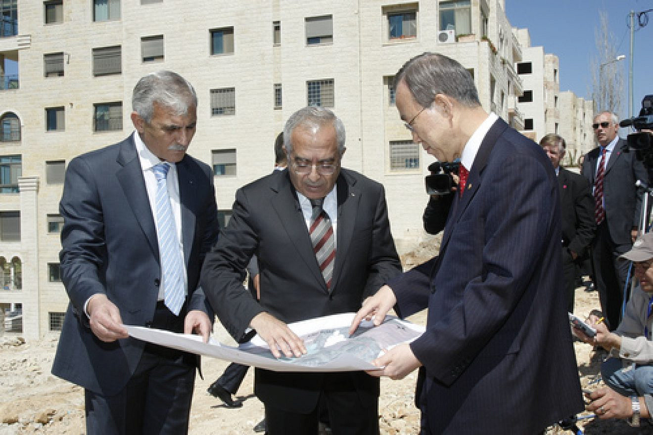 UN Secretary-General Ban Ki-moon (right) and Salam Fayyad (center), former Prime Minister of the Palestinian National Authority, look over a map during their visit to the West Bank's Area C, outside Ramallah. A new World Bank report, entitled “Area C and the Future of the Palestinian Economy,” blames Israel for shortcomings within the Palestinian economy. Credit: UN Photo/Mark Garten.