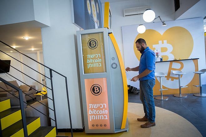 On Nov. 5, 2018, a man uses a bitcoin ATM machine at the Bitcoin Change center on Dizengoff Street in Tel Aviv. The center houses the ATM, as well as a museum on the history of the cryptocurrency. Credit: Miriam Alster/Flash90.