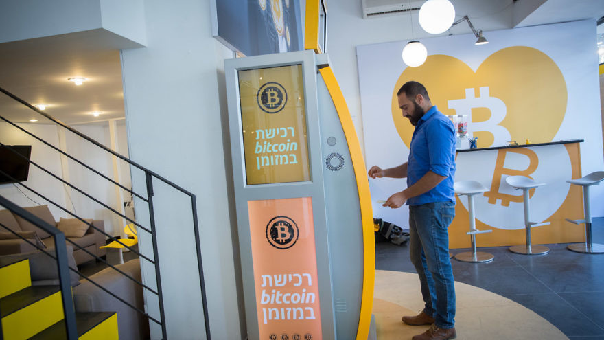 A man uses a bitcoin ATM machine at the Bitcoin Change center on Dizengoff Street in Tel Aviv on Nov. 5, 2023. Credit: Miriam Alster/Flash90.