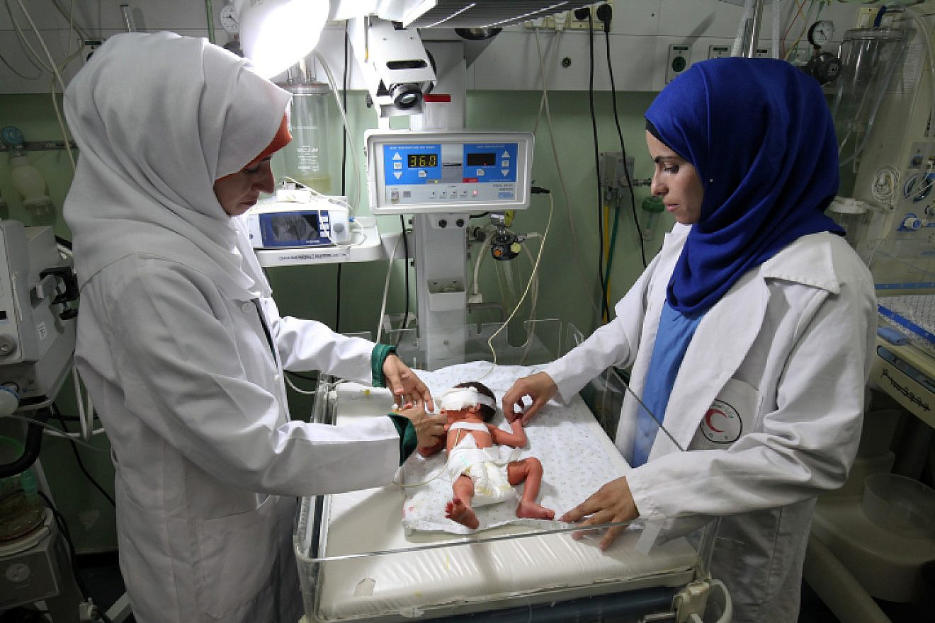 Palestinian nurse examined a baby at the Amarati Hospital in Rafah, south of the Gaza Strip, June 27, 2017. Photo by Abed Rahim Khatib/ Flash90