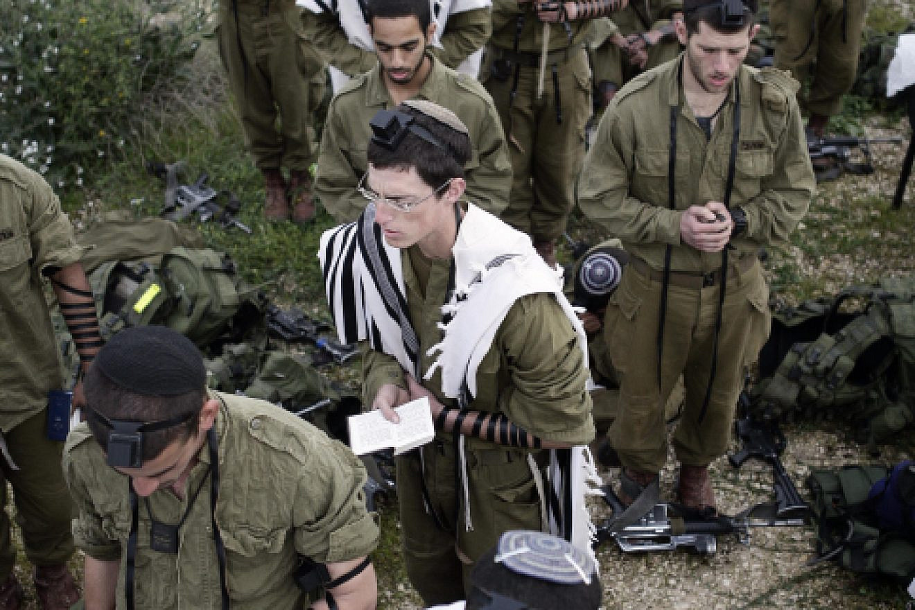 Israeli soldiers in the Neztah Yehuda Battalion (“Nahal Haredi”) complete the final stages of a 40-kilometer journey during the night on Feb. 16, 2010. Other military practices are being debated by a group of rabbis in Israel. Photo by Abir Sultan/Flash90.