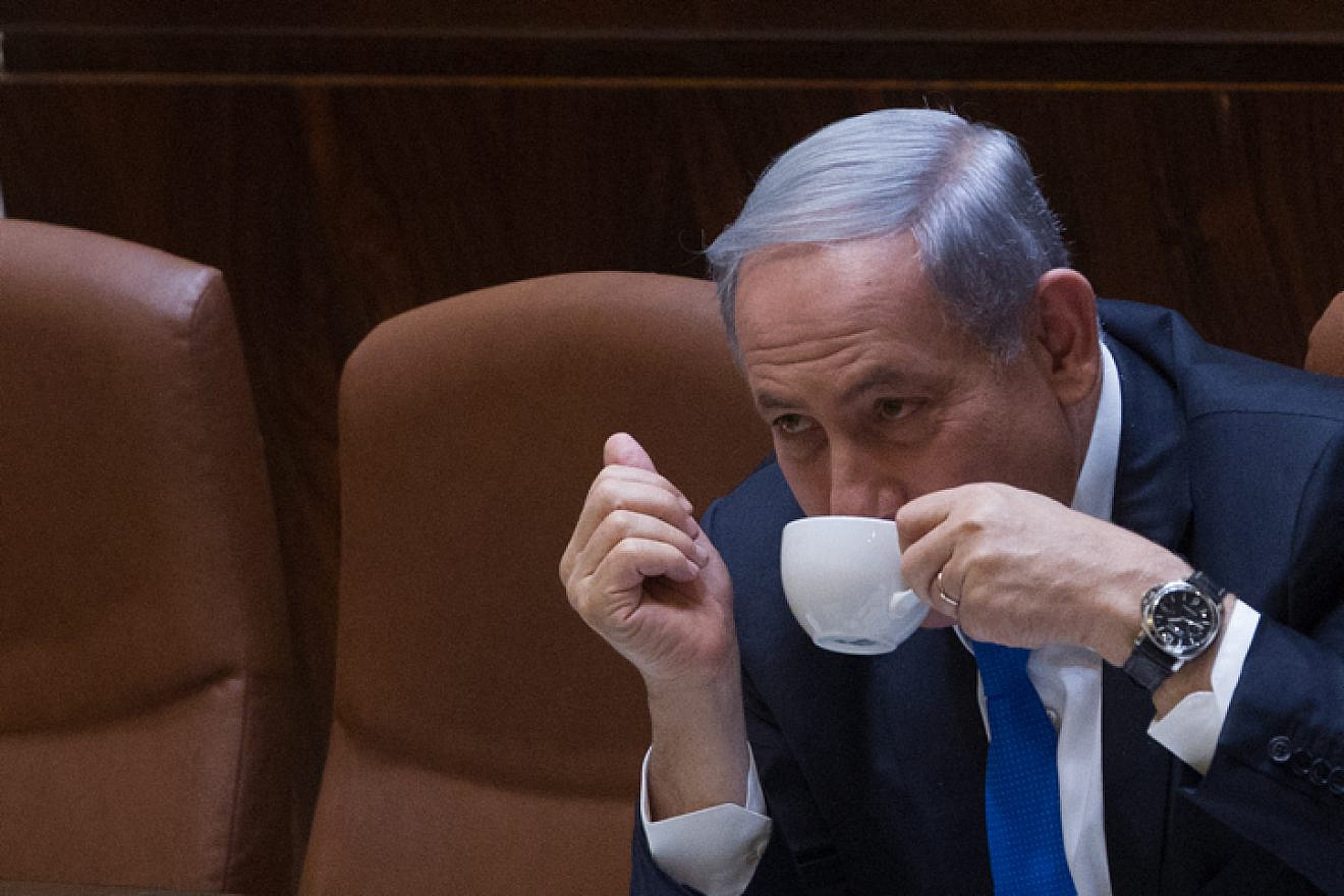 Israeli Prime Minister Benjamin Netanyahu seen drinking coffee during a plenum session in the assembly hall of the Israeli parliament on June 17, 2015. Photo by Miriam Alster/Flash90.
