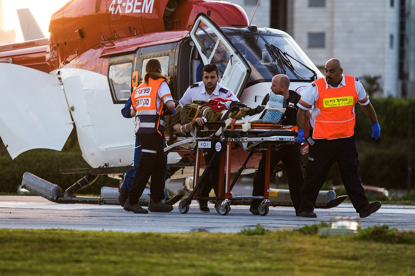 Medics evacuate a wounded Israeli soldier on March 16, 2018, after a group of IDF soldiers were injured in a car-ramming terror attack, resulting in two fatalities. Photo by Roy Alima/Flash90.