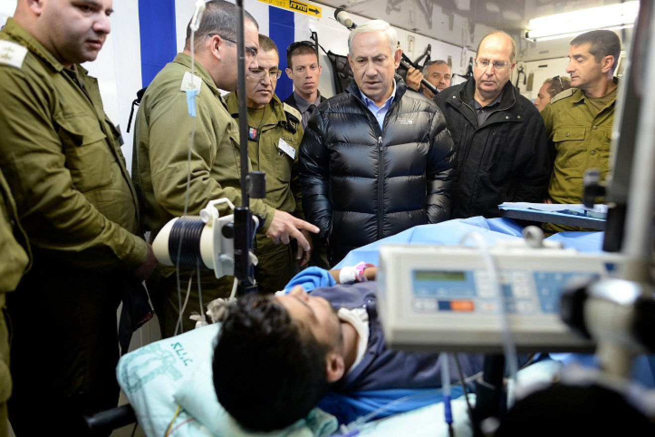 Israeli Prime Minister Benjamin Netanyahu visits at an IDF field hospital, where those wounded in the civil war in Syria were being treated in northern Israel. Feb. 18, 2014. Photo by Kobi Gideon/GPO/Flash90.