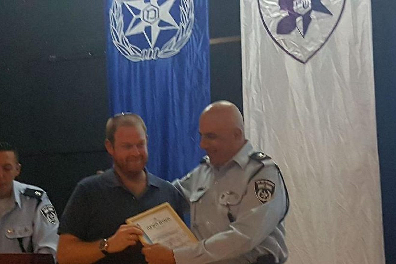 Ofek Kaufman earns an award for his quick action in helping a man who was fleeing from an attacker. Source: Israel Police.