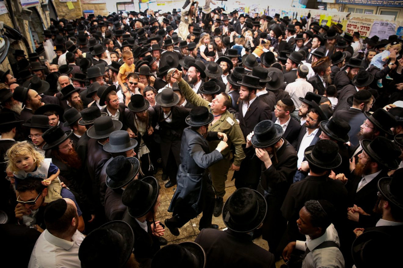 Jewish men celebrate the Jewish holiday of Lag B’Omer in the northern Israel town of Meron on May 3, 2018. Lag B’Omer commemorates the death of Rabbi Shimon bar Yochai, one of the most important sages in Jewish history, more than 1,800 years ago. Photo by David Cohen/Flash90.