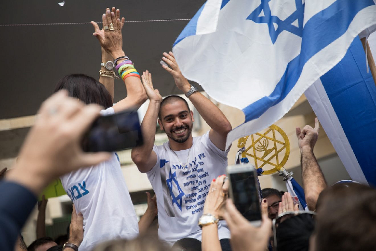 Elor Azaria, the Israeli soldier who shot dead a Palestinian attacker in Hebron on March 24, 2016, seen after his release from military prison as his family celebrates his return outside of their home in Ramle, May 8, 2018. Photo by Hadas Parush/Flash90.