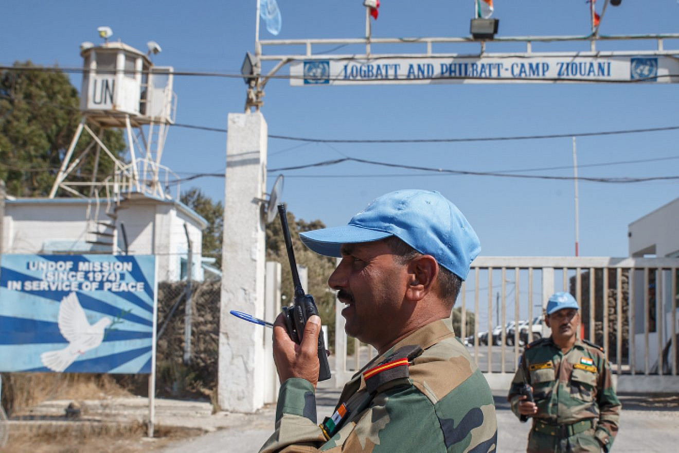 Members of the United Nations Disengagement Observer Force (UNDOF) stand near their post by the Quneitra crossing between Israel and Syria in the Israeli-annexed Golan Heights, on Aug. 30, 2014. U.N. peacekeepers caught up in heavy fighting on the Golan Heights were evacuated, while many of their colleagues were captured by Syrian rebels. Photo by Flash90.