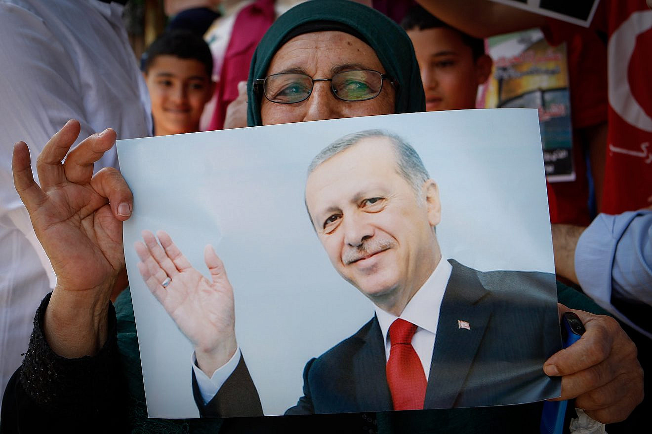 Palestinians holds pictures of the Turkish President Recep Tayyip Erdoğan as they wear shirts with Turkish flags in the West Bank city of Hebron on July 20, 2016. Photo by Wisam Hashlamoun/Flash90.