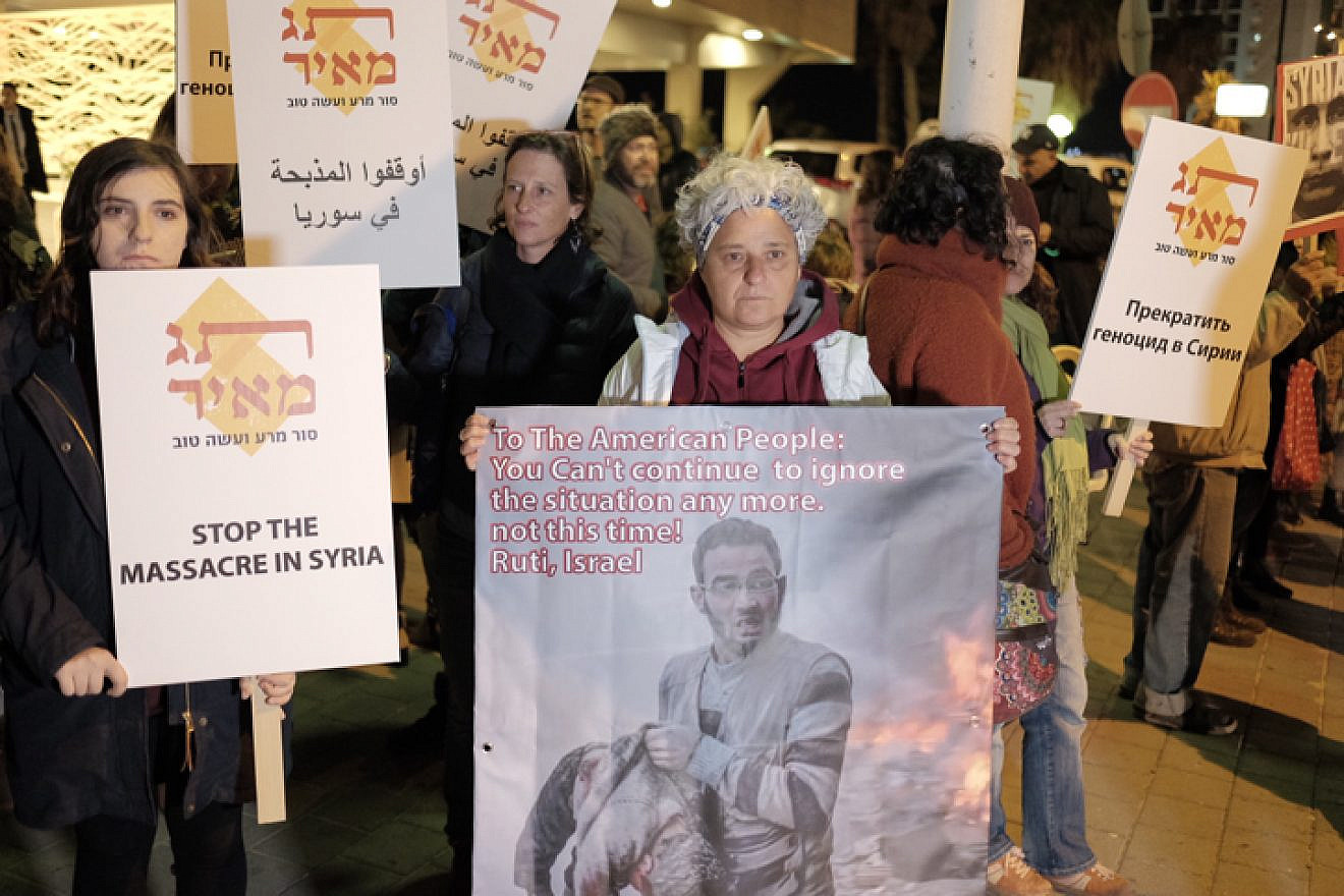 Protesters hold signs during a call to end the war in Syria near the Russian Embassy in Tel Aviv on Dec. 18, 2016. Photo by Tomer Neuberg/Flash90.