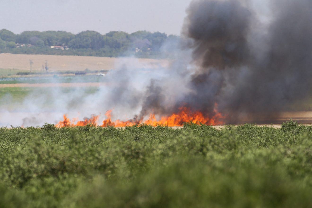Smoke rises from Israeli agricultural fields near the Israeli border with the Gaza Strip, after being set on fire by a flaming kite flown over by Palestinians as they protest by the border fence on May 14, 2018. Photo by Flash90.