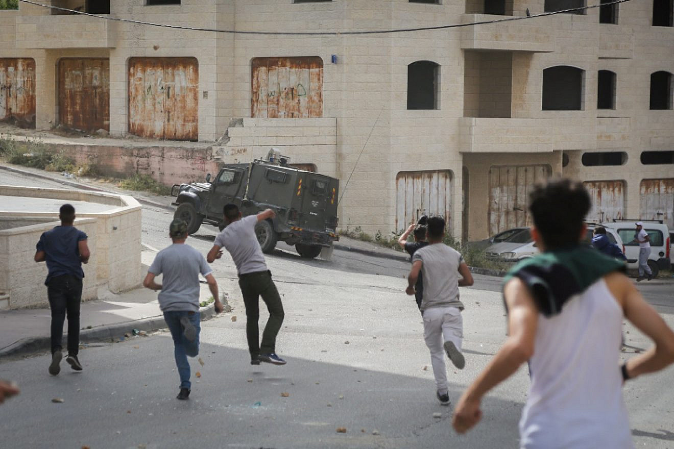 Palestinians clash with Israeli security forces during a raid of the Israeli army in the West Bank village of al-Am’ari near Ramallah on May 28, 2018. Photo by Flash90.