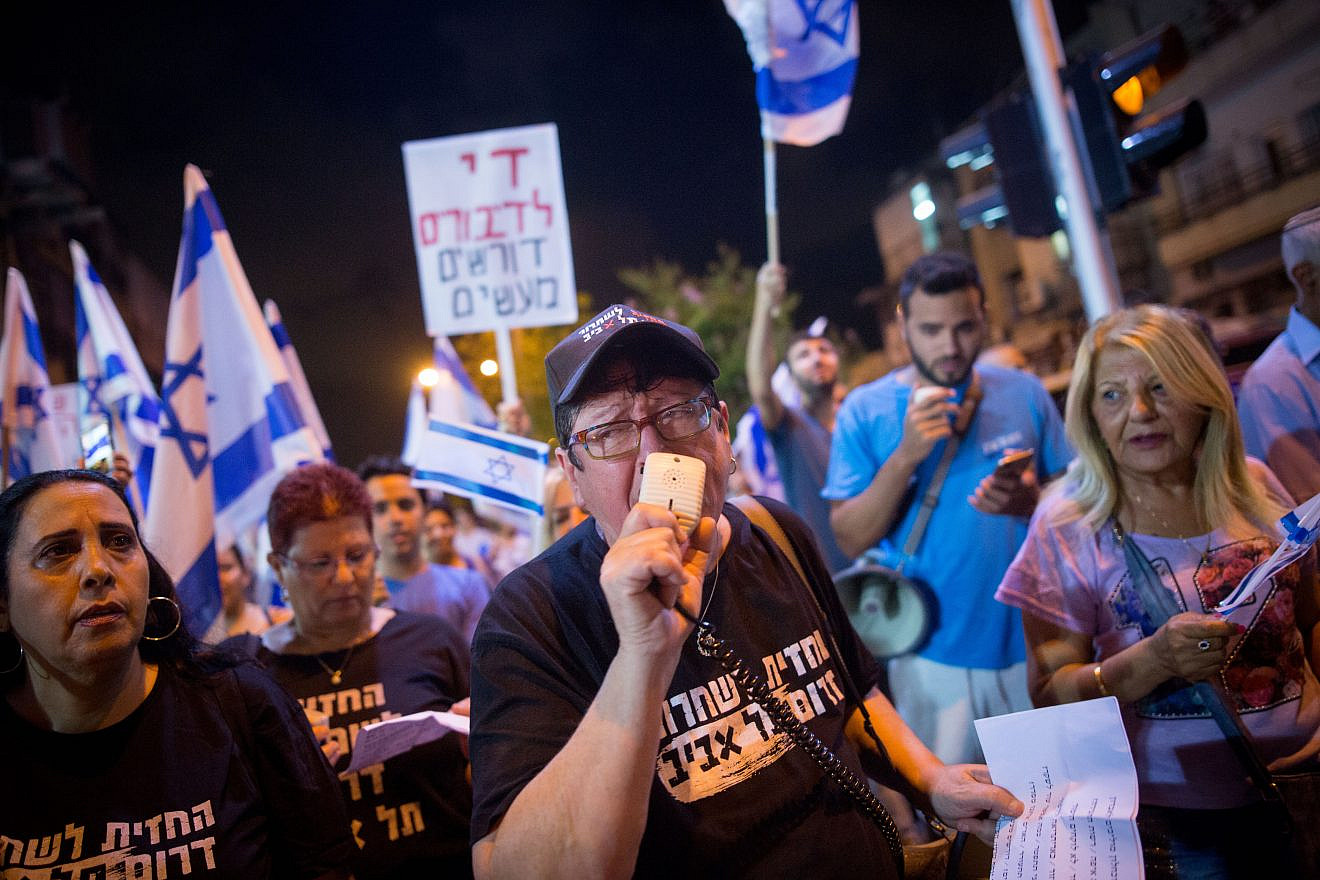 Sheffi Paz with other South Tel Aviv residents holding placards during a protest march against African asylum-seekers in South Tel Aviv on June 2, 2018. Photo by Miriam Alster/Flash90.