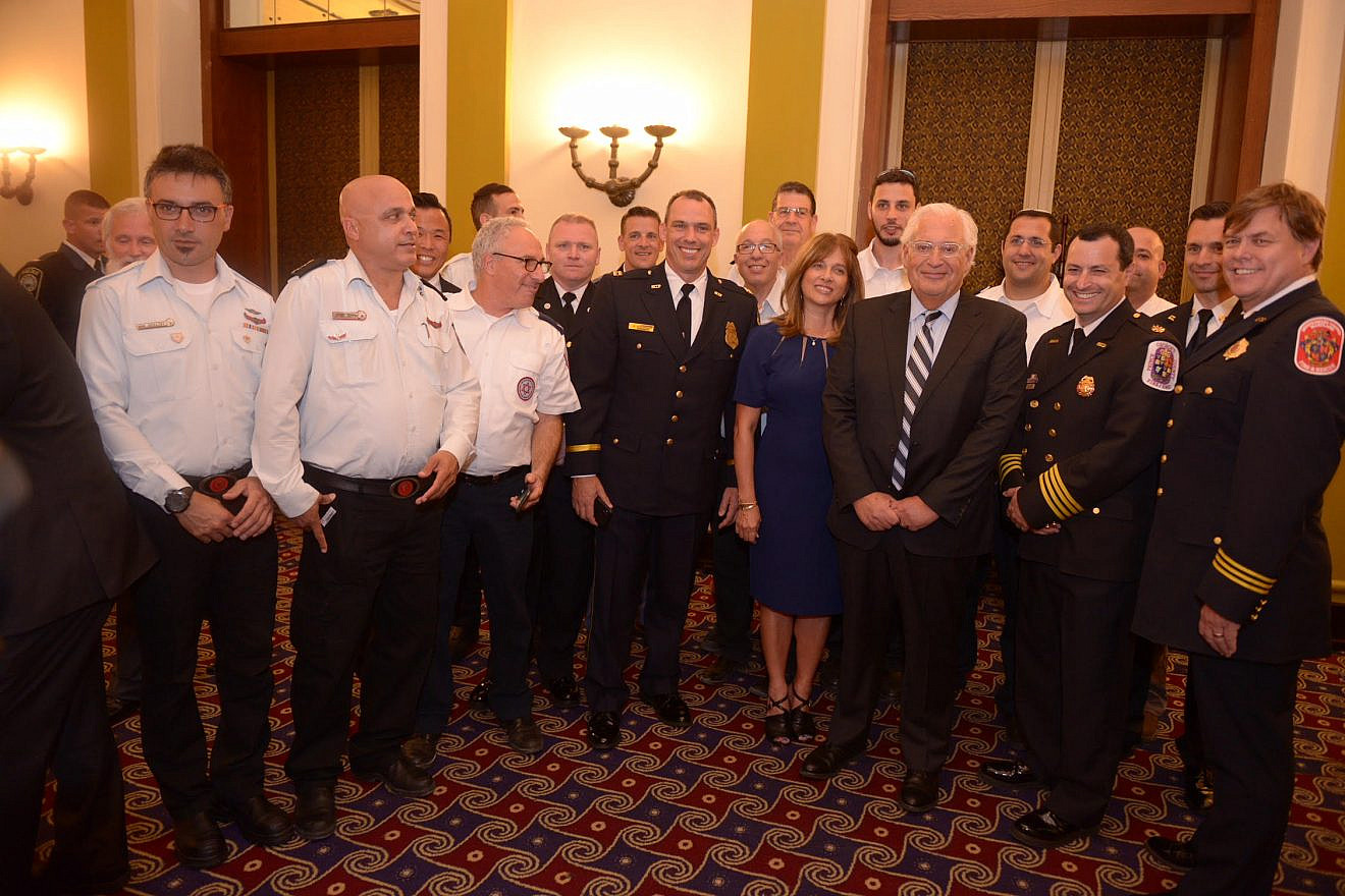 U.S. and Israeli first responders gather around U.S. Ambassador David Friedman at an ASTI dinner and awards ceremony held in their honor. Credit: Binyamin Ben Kahlon
