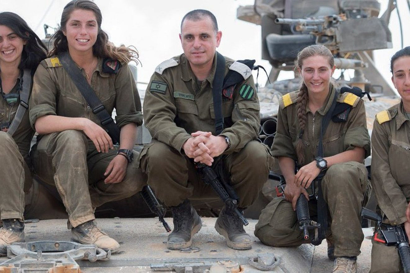 The first four female tank commanders in the Israel Defense Forces pose with Brig. Gen. Guy Hasson, head of the Armored Corps. Credit: IDF Spokesperson Unit.