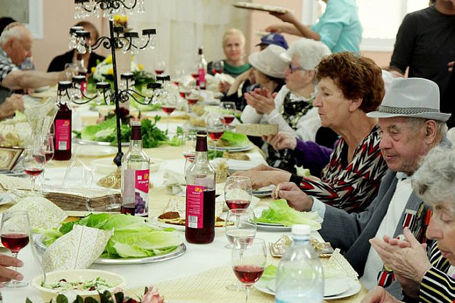 Senior citizens enjoy a meal for the upcoming Jewish holiday of Passover, organized by the "Keren Leyedidut"(International Fellowship of Christians and Jews) organization, in the southern Israeli town of Sderot. April 10, 2014. Photo by Edi Israel/Flash90.