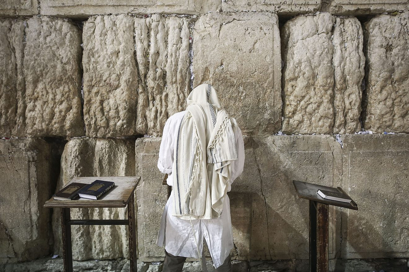 A Jewish worshipper at the Western Wall in the Old City of Jerusalem at the end of Yom Kippur, the Day of Atonement, and the holiest of Jewish holidays. Israel comes to a standstill for 25 hours during the holiday, when Jews traditionally fast and Israelis are prohibited from driving. Photo by Flash90.