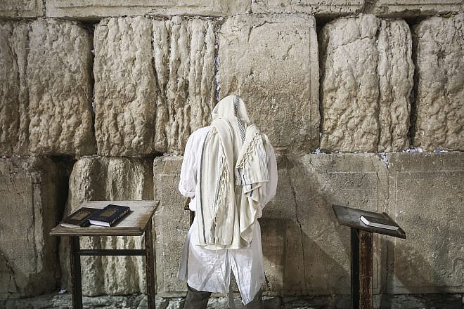 A Jewish worshipper at the Western Wall in the Old City of Jerusalem at the end of Yom Kippur, the Day of Atonement, and the holiest of Jewish holidays. Israel comes to a standstill for 25 hours during the holiday, when Jews traditionally fast and Israelis are prohibited from driving. Photo by Flash90.